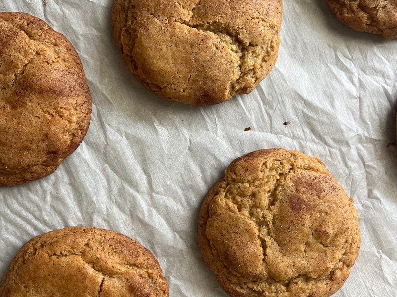 brown butter snickerdoodles cooling on parchment